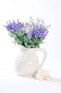 wild flowers in a white vase on a white background.