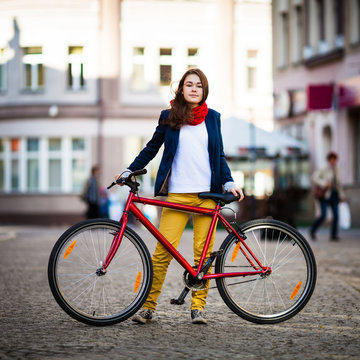 Urban biking - teenage girl and bike in city