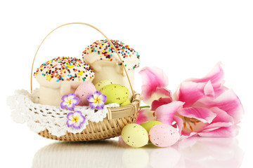 Easter cakes with eggs in wicker basket isolated on white