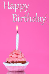 Beautiful cupcake with candle on pink background