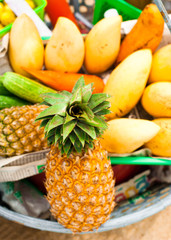 Selling tropical fruits and vegetables at market