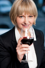 Corporate lady drinking red wine