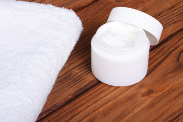 Cream and white towel on the background of oak table