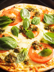 pizza with tomatoes and basil