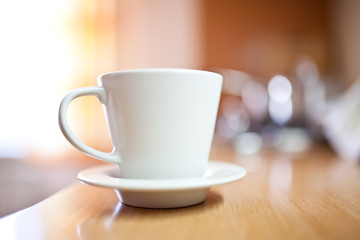 Cup of coffee or tea on wooden table, small dof