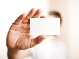 Fototapeta premium Human hand holding blank business card with copy space, small do
