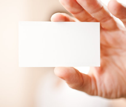 Human hand holding blank business card with copy space, small do