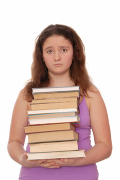 Sad girl holds a stack of books.