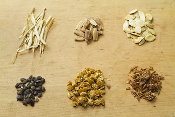 Seeds on wooden background.