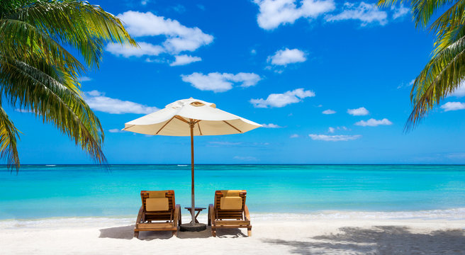 Fototapeta two deckchairs on the idyllic white beach turquoise sea