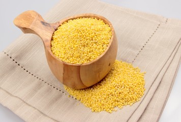 millet groats in wooden mug