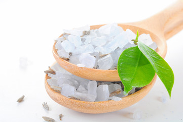 Sea salt poured from wooden spoon