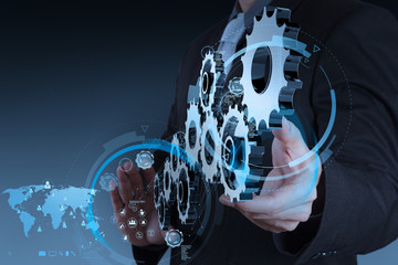 businessman hand working with coggear to success