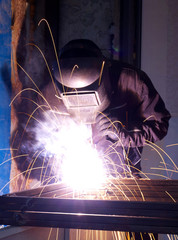 Welder on the factory. Industrial composition