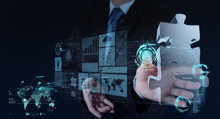 businessman hand working with computer interface show puzzles