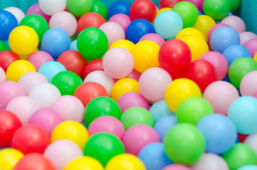 Fototapeta na wymiar A lot of coloured plastic balls in playroom