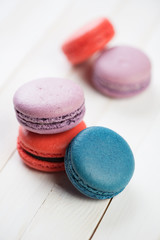 Brightly coloured macaroons on wooden boards, studio shot