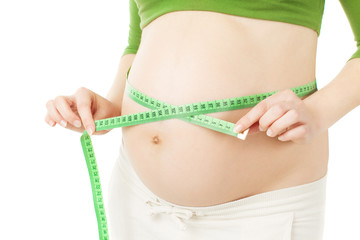 pregnant woman measuring belly