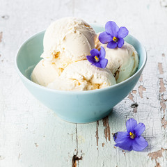 Vanilla ice cream decorated violet flower