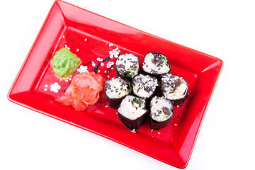 Vegetarian sushi roll served on a red plate