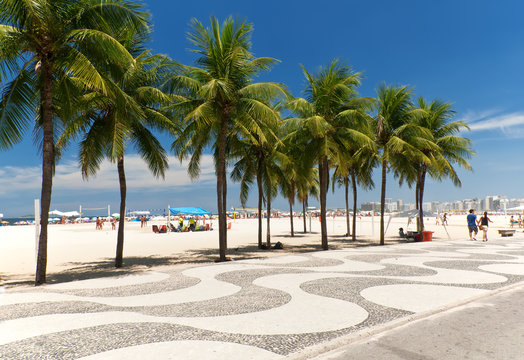 Copacabana with palms and mosaic of sidewalk in Rio de Janeiro