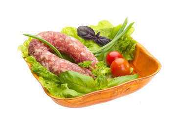Ripe salami with salad, basil, onion and tomato
