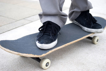 Boy's foot stepping on skateboard