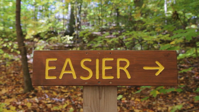 Easier and Harder signs on Mountain Bike trails. Two shots.
