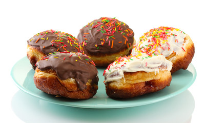 Tasty donuts on color plate isolated on white