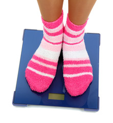 Feet on scales isolated on white