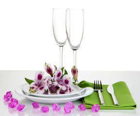 Festive table setting with flowers isolated on white