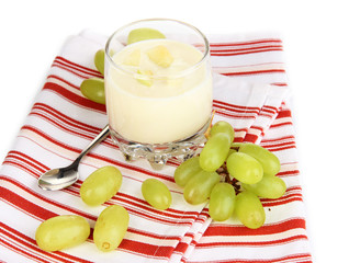 Delicious yogurt in glass with grapes isolated on white