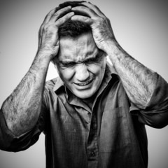 Black and white image of an angry sufering man in pain