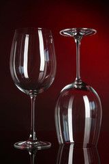 Two glasses on dark red background