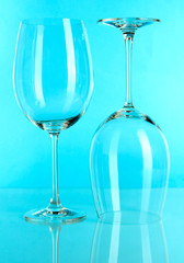 Two glasses on light blue background