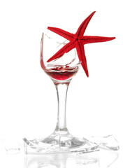 Broken wineglass with sea star isolated on white