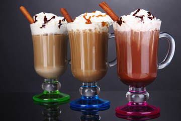 Layered coffee in glass on table on grey background
