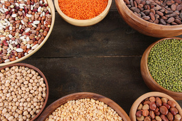 Different kinds of beans in bowls on  table close-up