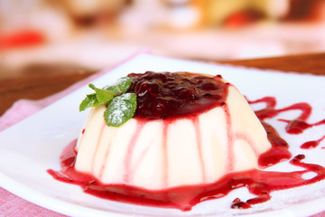 Panna Cotta with raspberry sauce, on bright background