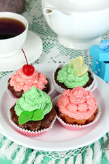 Delicious beautiful  cupcakes on dining table close-up