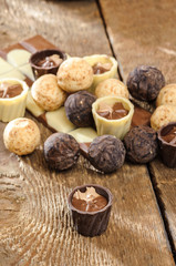 chocolates and chocolate in a basket on a wooden table