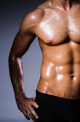 Fototapeta premium Muscular man in dark studio