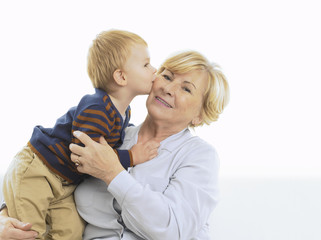 Grandmother getting a kiss from grandson