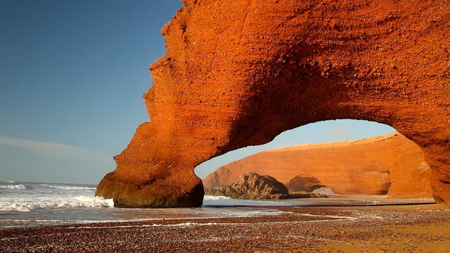 Red archs on atlantic ocean coast. Morocco