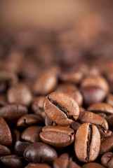 Closeup of coffee beans with focus on one