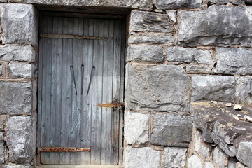 Interesting carved door in stone wall