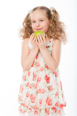 Small and beautiful girl with green apple