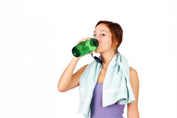 Sporty young woman drinking water