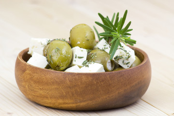 feta cheese and olives with herbs in olive oil