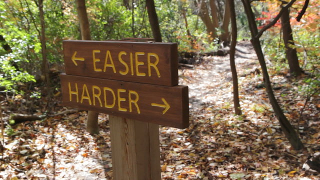 Easier or Harder trail. Biker goes by. Toronto.